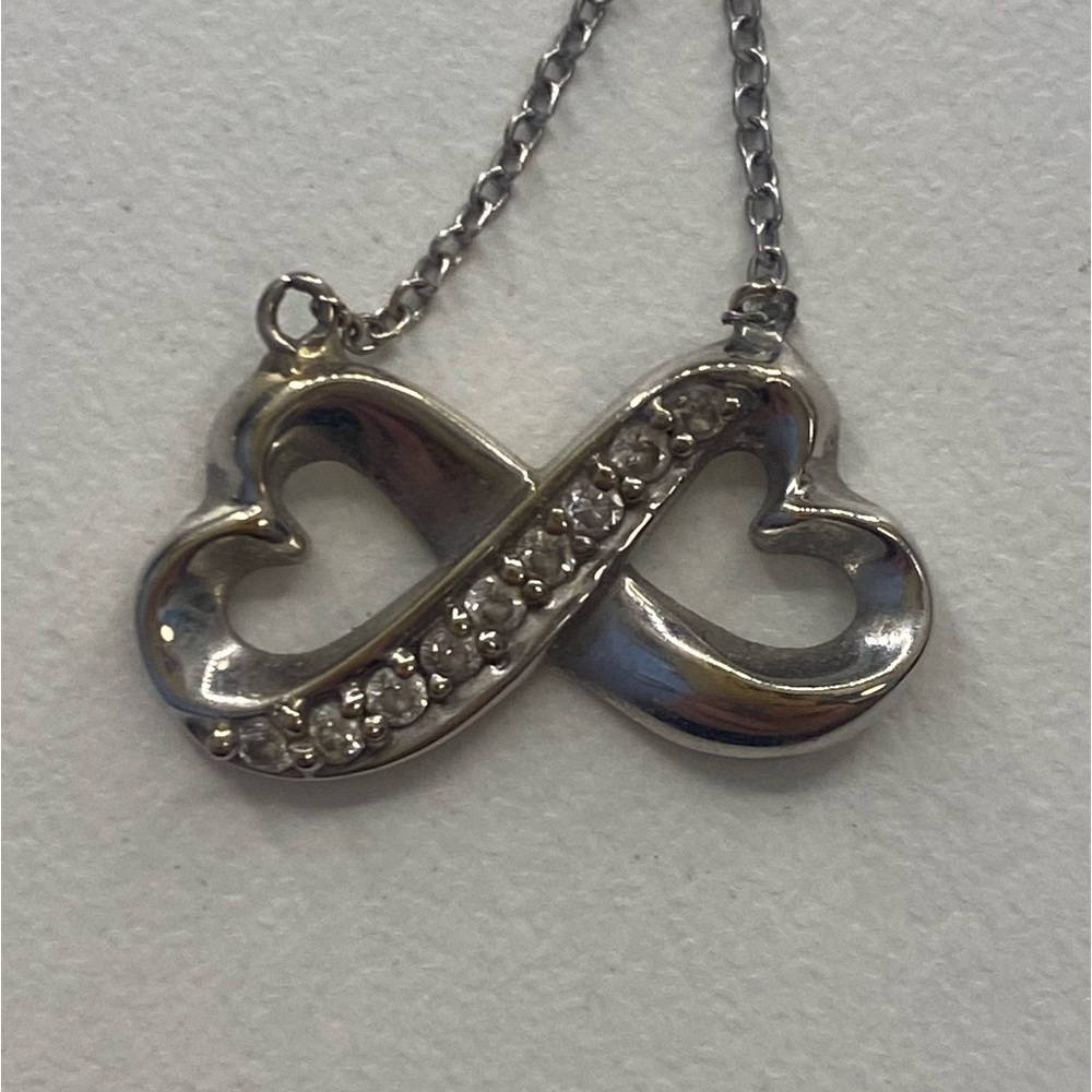 White gold and diamond heart infinity pendant.